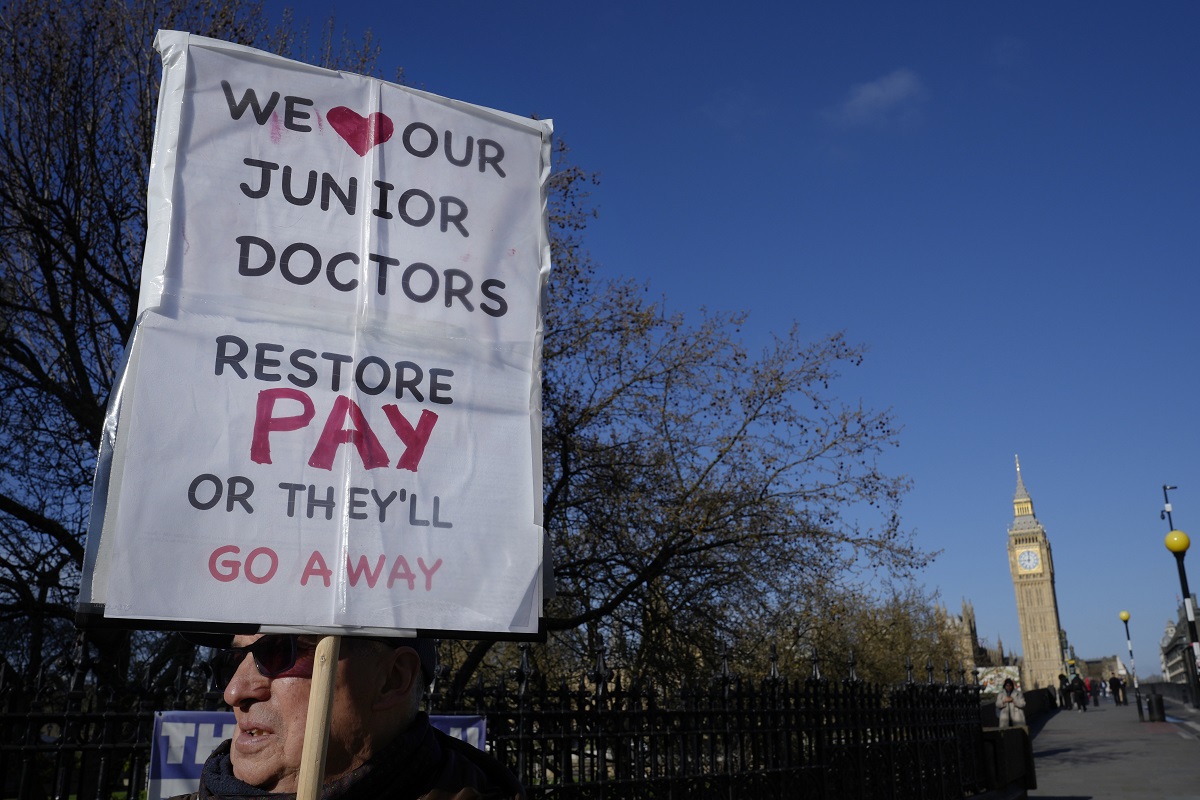 britian strike junior doctors and supporters hold placards near big ben