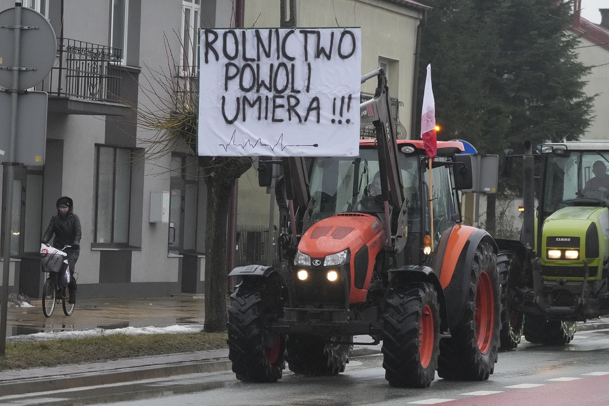 protesting farmers in poland are slow driving their tractors on a road in deblin poland